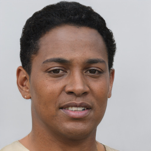 Joyful black young-adult male with short  brown hair and brown eyes