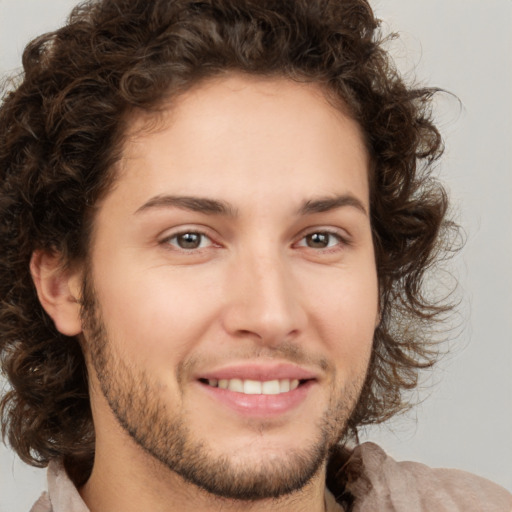 Joyful white young-adult male with medium  brown hair and brown eyes