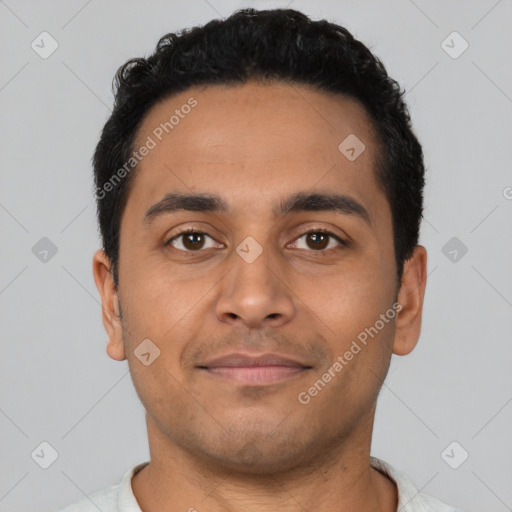 Joyful latino young-adult male with short  black hair and brown eyes