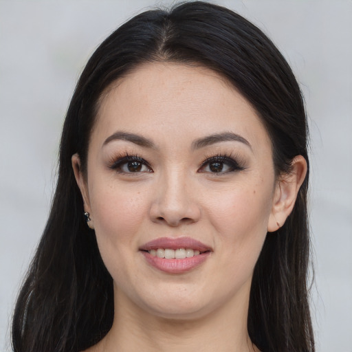 Joyful asian young-adult female with long  brown hair and brown eyes