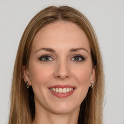 Joyful white young-adult female with long  brown hair and brown eyes