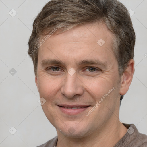 Joyful white adult male with short  brown hair and brown eyes