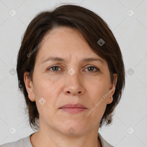 Joyful white adult female with medium  brown hair and brown eyes