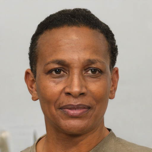 Joyful black adult male with short  black hair and brown eyes
