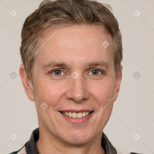 Joyful white adult male with short  brown hair and grey eyes