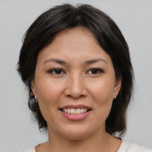 Joyful asian young-adult female with medium  brown hair and brown eyes