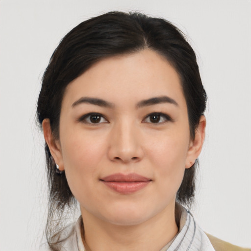 Joyful asian young-adult female with medium  black hair and brown eyes