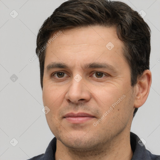 Joyful white adult male with short  brown hair and brown eyes