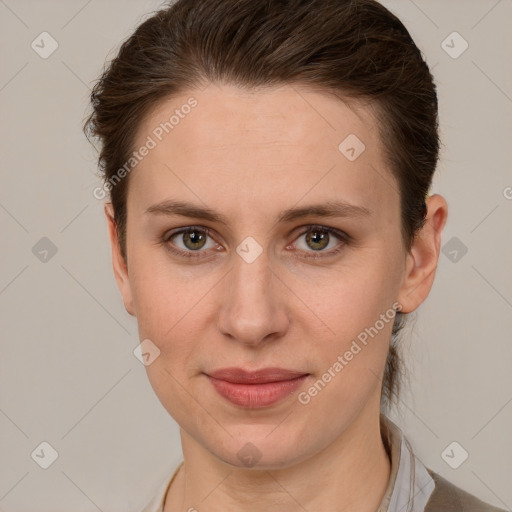 Joyful white young-adult female with short  brown hair and grey eyes