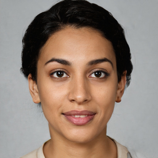 Joyful latino young-adult female with short  black hair and brown eyes