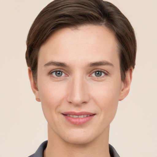 Joyful white young-adult female with short  brown hair and grey eyes