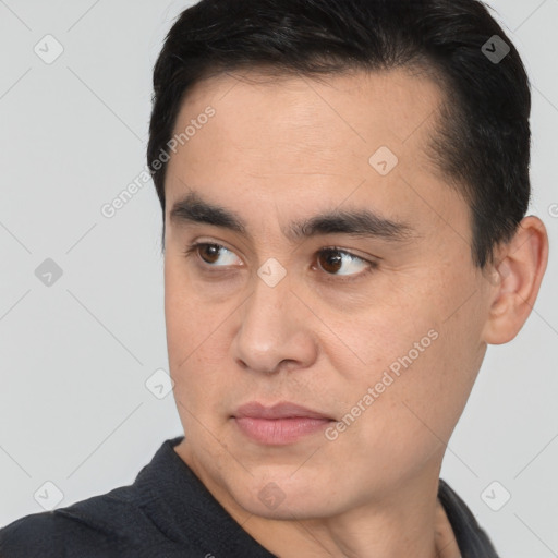 Joyful white young-adult male with short  black hair and brown eyes