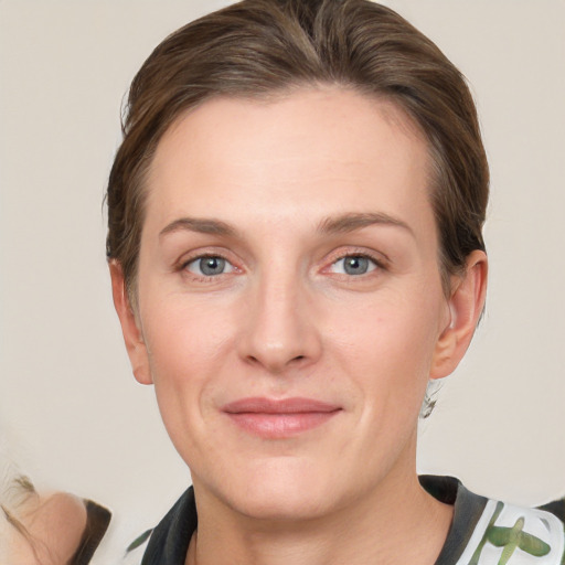 Joyful white adult female with medium  brown hair and grey eyes