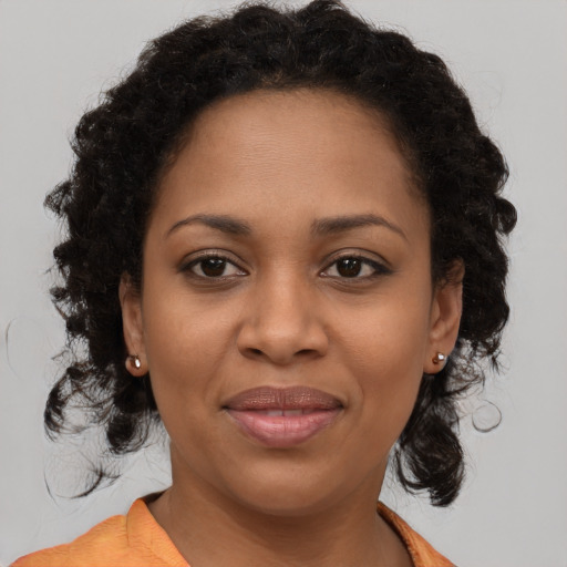 Joyful black young-adult female with medium  brown hair and brown eyes