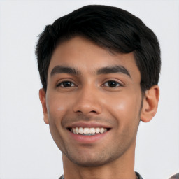 Joyful latino young-adult male with short  black hair and brown eyes