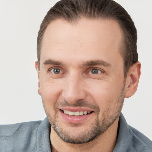 Joyful white adult male with short  brown hair and brown eyes