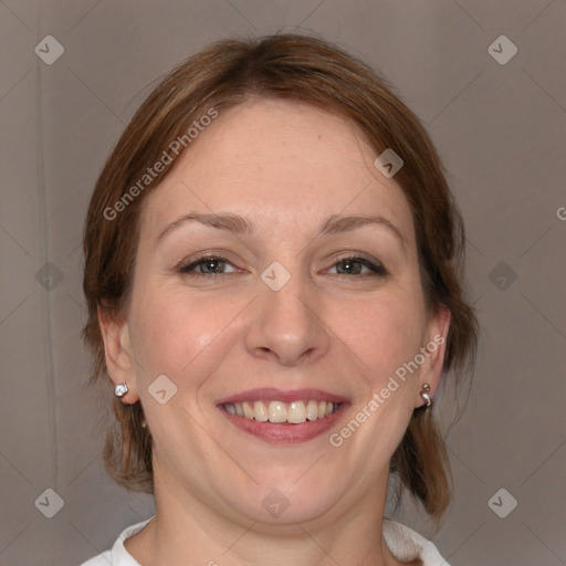 Joyful white adult female with medium  brown hair and blue eyes