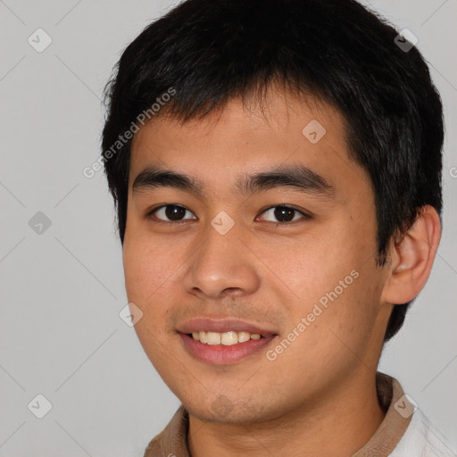 Joyful asian young-adult male with short  black hair and brown eyes