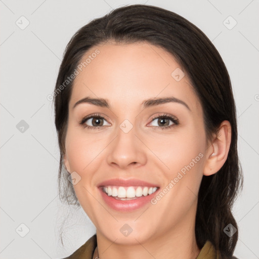 Joyful white young-adult female with long  brown hair and brown eyes