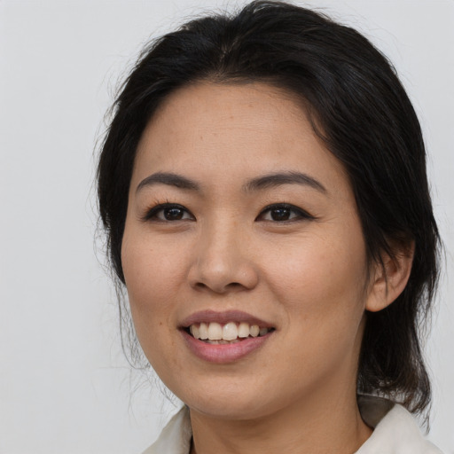 Joyful asian young-adult female with medium  brown hair and brown eyes