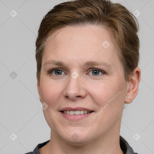 Joyful white young-adult female with short  brown hair and grey eyes