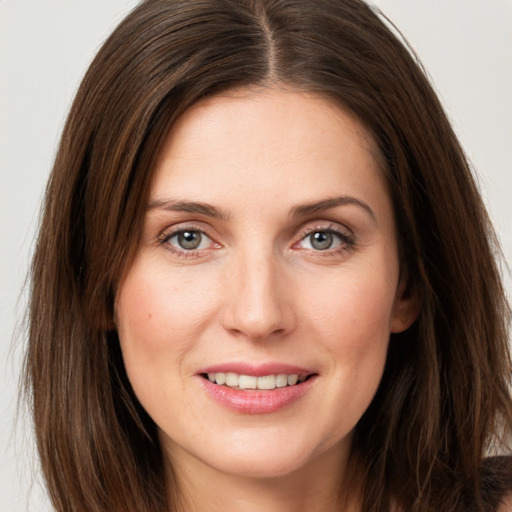 Joyful white young-adult female with long  brown hair and grey eyes