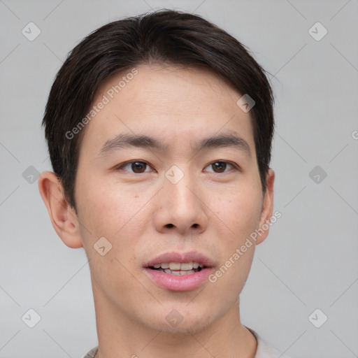 Joyful asian young-adult male with short  brown hair and brown eyes