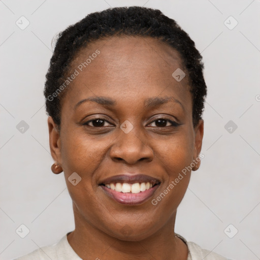 Joyful black young-adult female with short  black hair and brown eyes