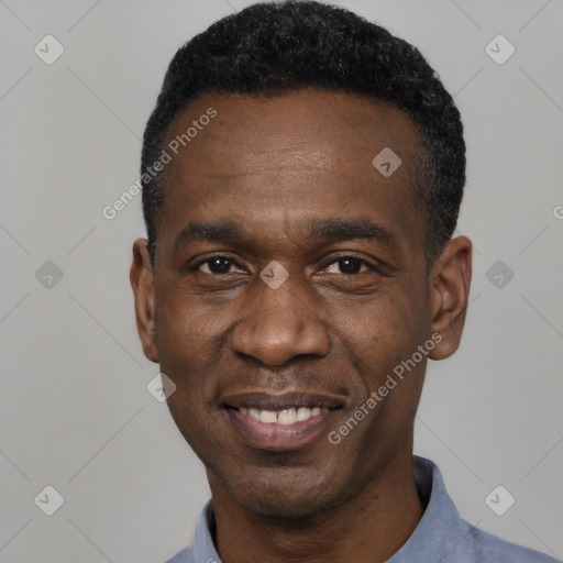 Joyful black adult male with short  black hair and brown eyes