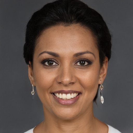 Joyful black young-adult female with short  brown hair and brown eyes