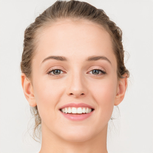 Joyful white young-adult female with medium  brown hair and blue eyes