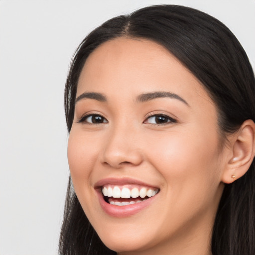 Joyful white young-adult female with long  black hair and brown eyes