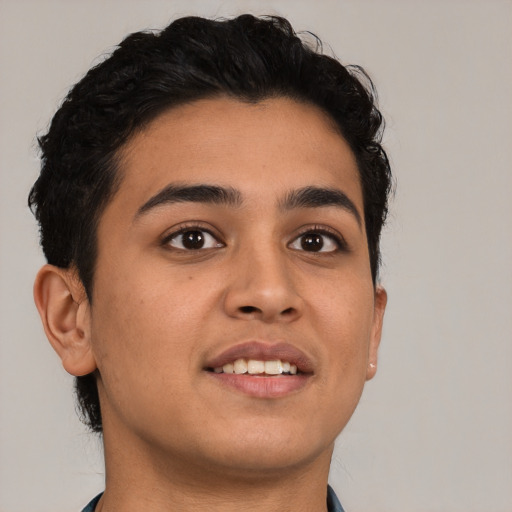 Joyful latino young-adult male with short  brown hair and brown eyes