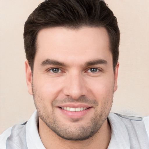 Joyful white young-adult male with short  brown hair and brown eyes