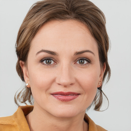 Joyful white young-adult female with medium  brown hair and grey eyes