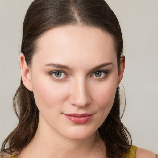 Joyful white young-adult female with long  brown hair and blue eyes