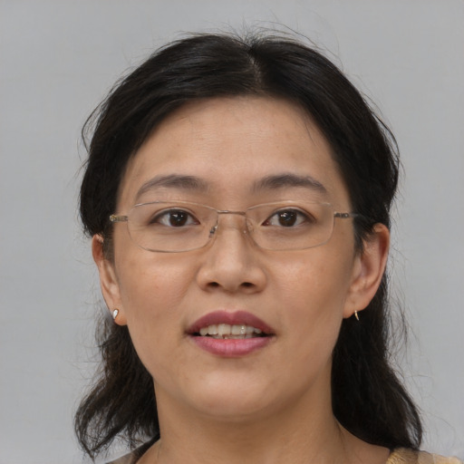 Joyful asian adult female with medium  brown hair and brown eyes