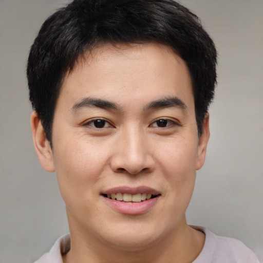 Joyful asian young-adult male with short  brown hair and brown eyes