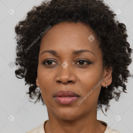 Joyful black adult female with medium  brown hair and brown eyes