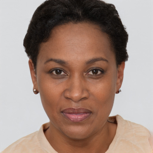Joyful black adult female with short  brown hair and brown eyes