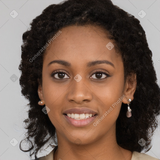 Joyful black young-adult female with long  black hair and brown eyes