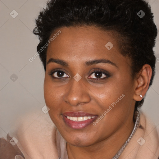 Joyful black young-adult female with short  brown hair and brown eyes