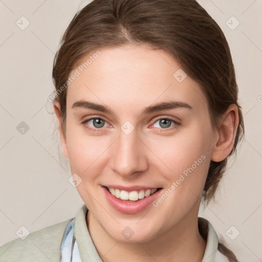 Joyful white young-adult female with medium  brown hair and grey eyes