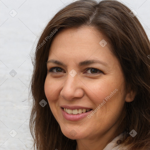 Joyful white adult female with long  brown hair and brown eyes