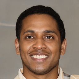 Joyful latino young-adult male with short  brown hair and brown eyes