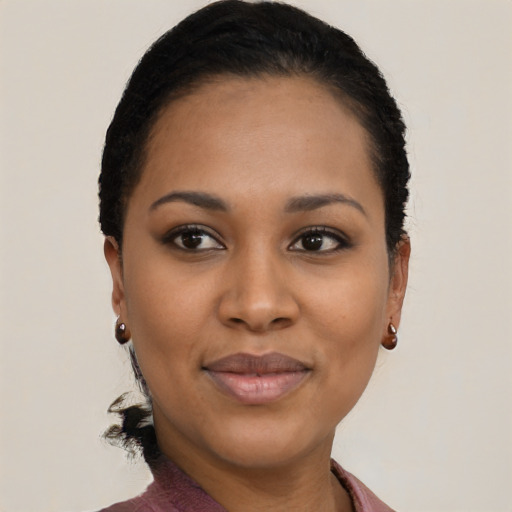 Joyful black young-adult female with short  black hair and brown eyes