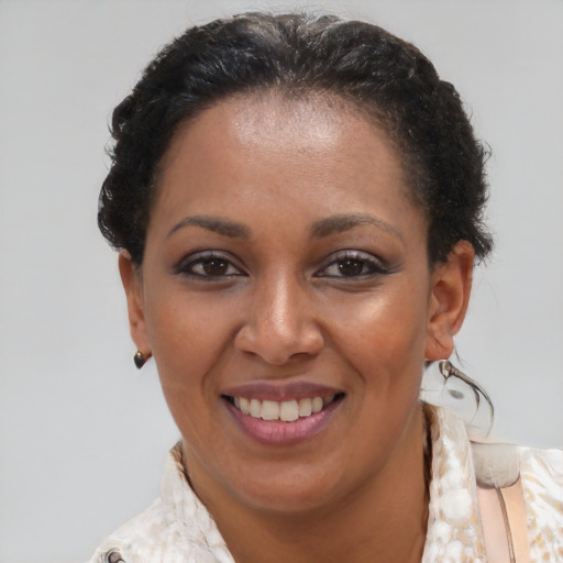 Joyful black adult female with medium  brown hair and brown eyes