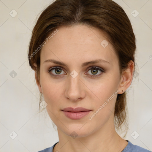 Joyful white young-adult female with medium  brown hair and green eyes