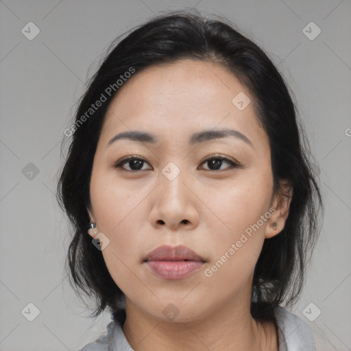 Joyful asian young-adult female with medium  black hair and brown eyes