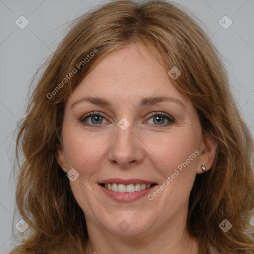 Joyful white adult female with medium  brown hair and blue eyes